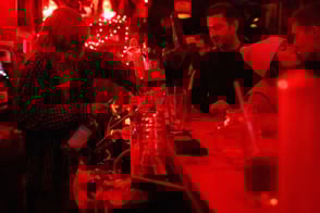 bartender pours drinks for customers