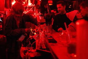 bartender pours drinks for customers