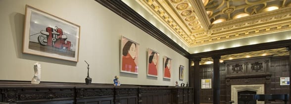 Wood-paneled room with art pieces