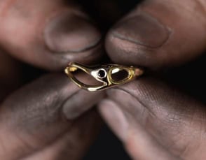 dirty hands holding gold ring