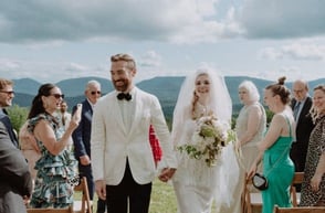 man and woman walk down aisl