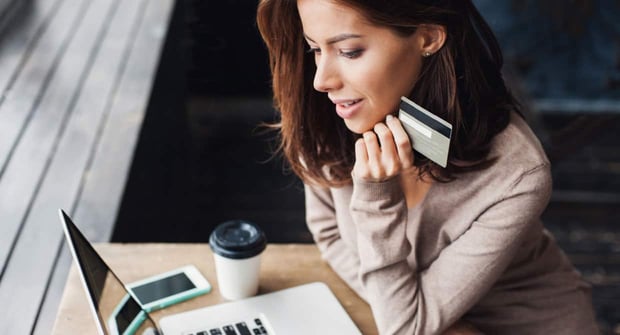 curious woman holding card image