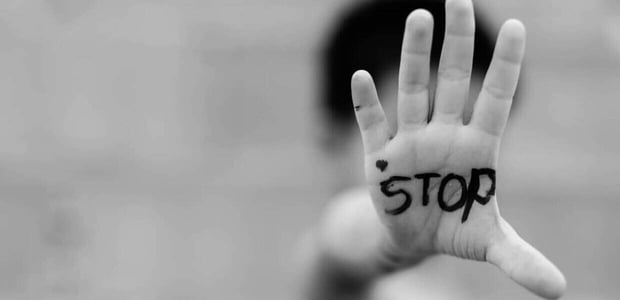 A hand with "stop" written on it.