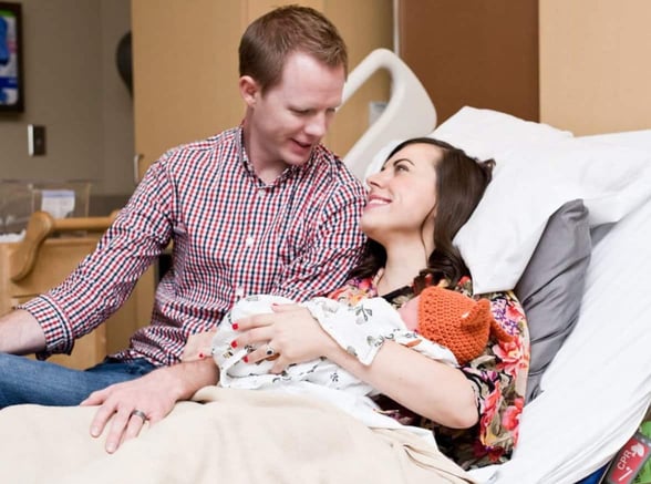 camille and her husband with their child