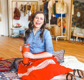 woman sitting on floor smiling at camera