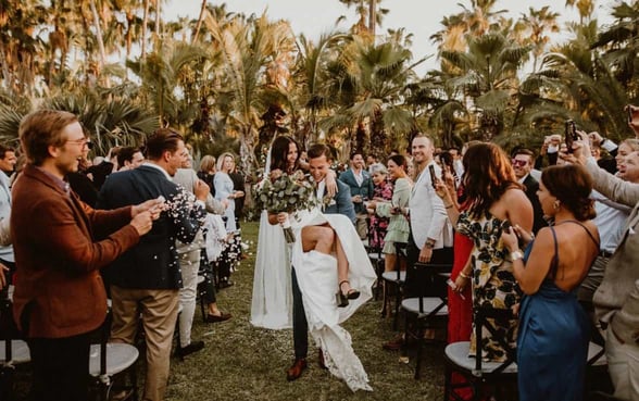 married couple going down the aisle at acre resort