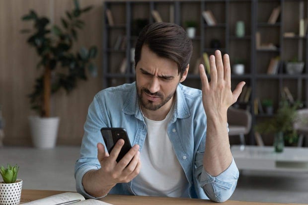 Photo of impatient man on the phone