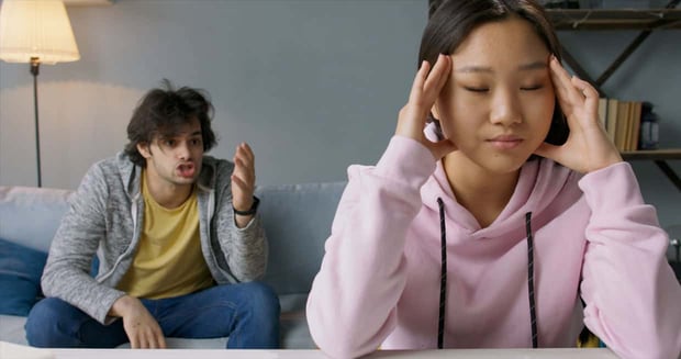 Photo of man talking to annoyed woman