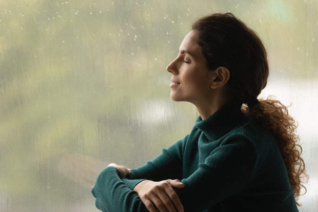 Photo of woman relaxing by a window