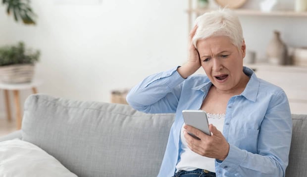 Photo of senior citizen reacting to scam