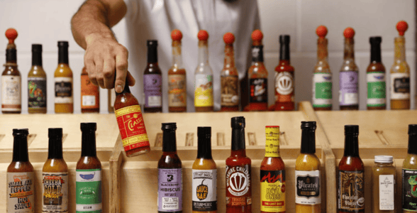 Heatonist employee picking up sauce bottle Heatonist employee picking up sauce bottle