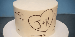 white tree trunk carving wedding cake
