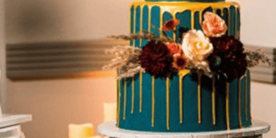 teal and gold wedding cake with flowers