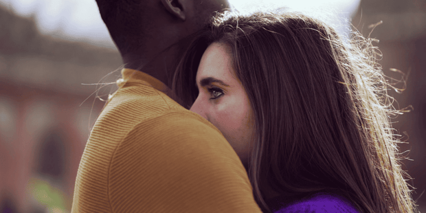Interracial couple with black man holding upset white woman Interracial couple with black man holding upset white woman