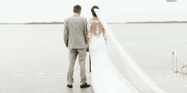Bride and groom looking out onto the beach
