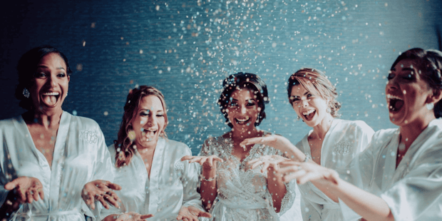 Bridesmaids popping confetti