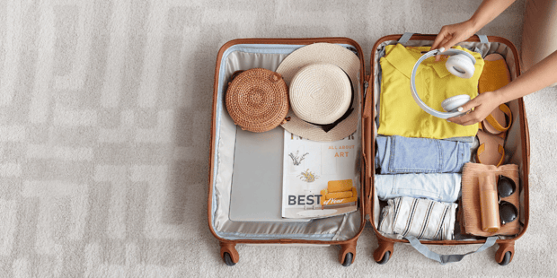Woman packing suitcase for travel Woman packing suitcase for travel