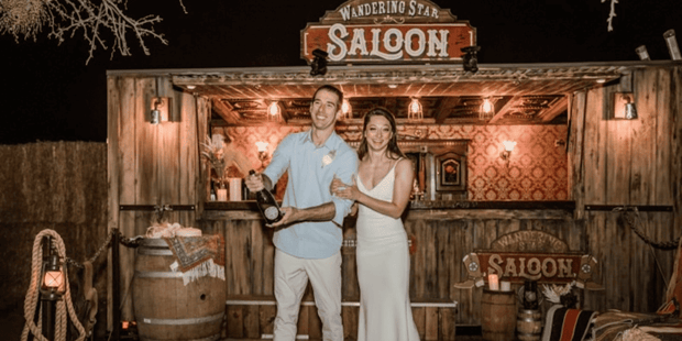 Couple in front of Wandering Star Saloon at Sandy Valley Ranch