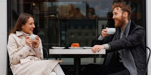international couple sipping coffee