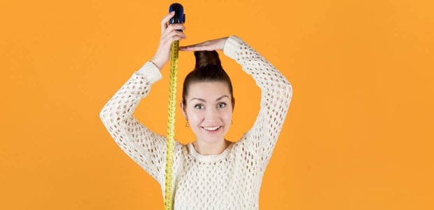 tall woman measuring herself tall woman measuring herself