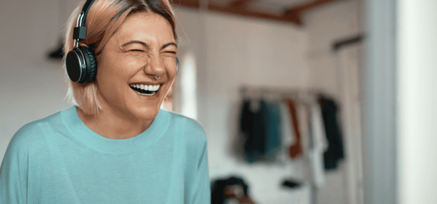Woman laughing with headphones on