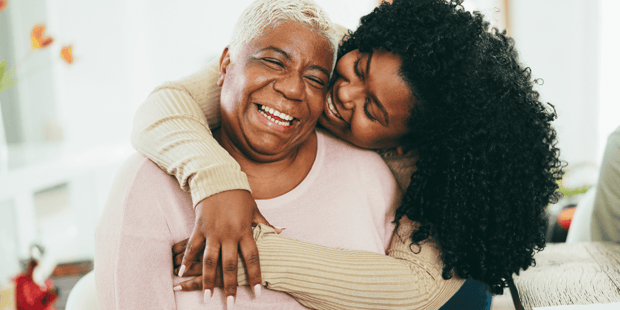 Black mom and daughter hugging