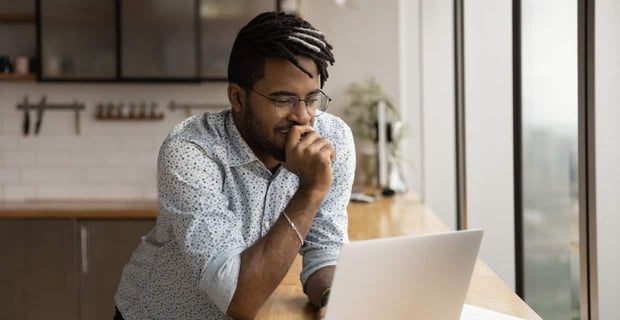 Photo of a man on his computer
