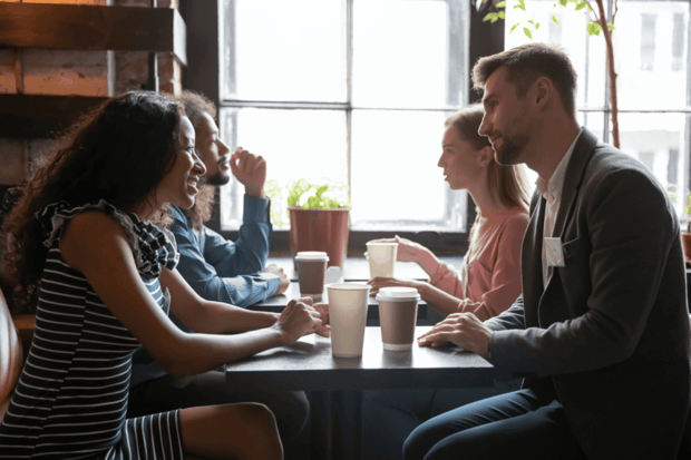 Several young men and women chatting at tables Several young men and women chatting at tables