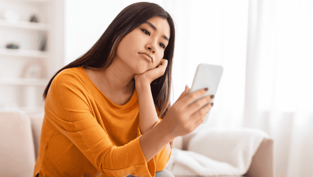 Woman sad looking at phone