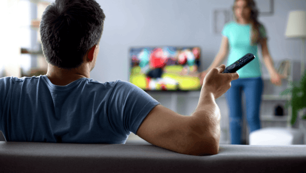 Stock photo of a man watching TV while woman is upset Stock photo of a man watching TV while woman is upset