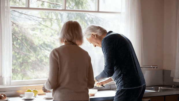 Stock photo of older couple cooking together