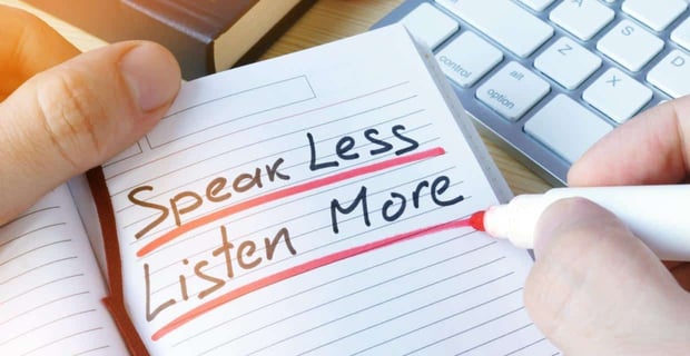 Notepad reading "speak less. Listen more."
