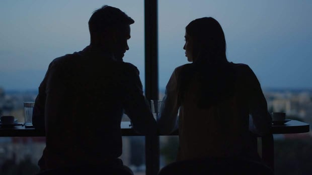 Couple in shadow sitting at table