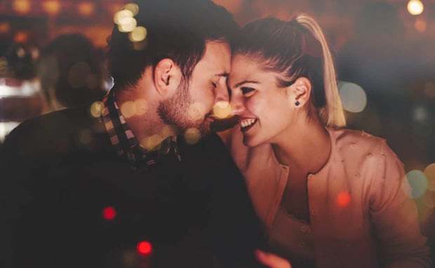 Couple on date foreheads touching