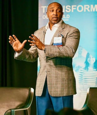 Dr. D Ivan Young public speaking plaid suit