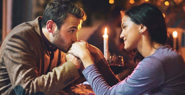 Photo of a man kissing a womans hands