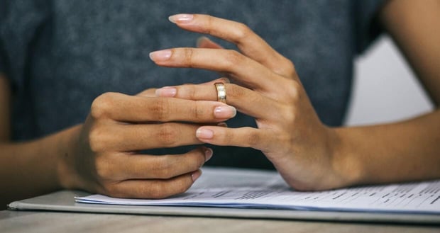 Woman taking off wedding ring Woman taking off wedding ring