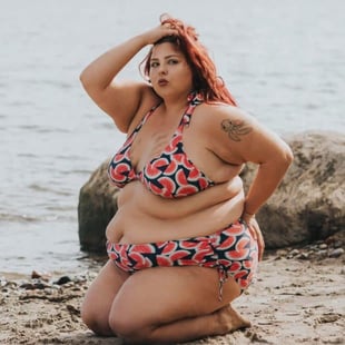 Curvy woman posing on beach with watermelon swimsuit