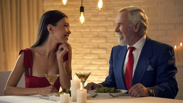 Young woman and old man at dinner