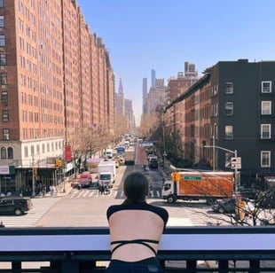 Screenshot from Matchmaker Alexandra of woman looking over ledge to city street