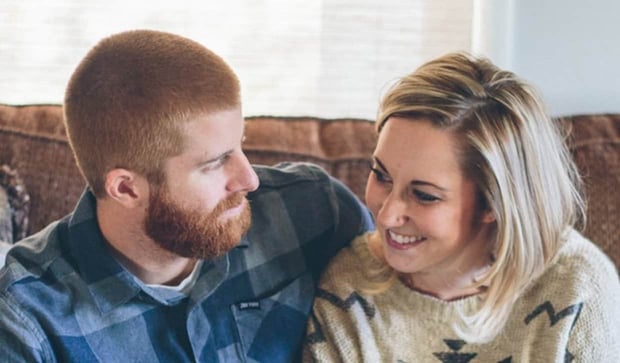 Bull City couple talking on couch