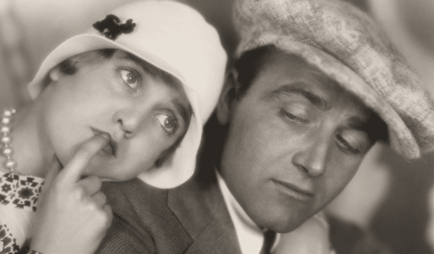 Vintage couple cuddling in hats