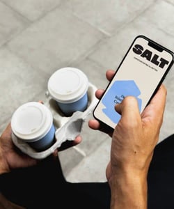 person holding phone using SALT dating app