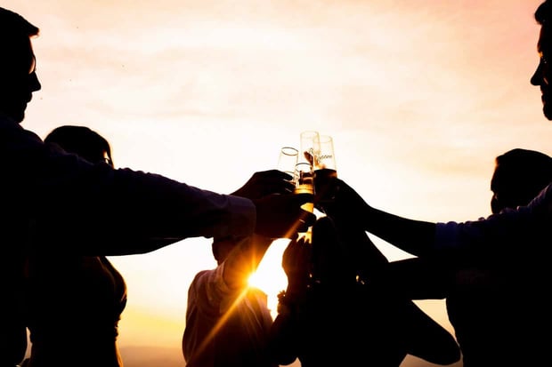 Michael Freas Photography sunset group clinking champagne glasses