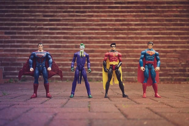 Classic male action figures of Superman, Joker, and Robin