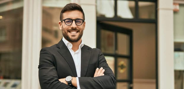 Photo of a man in a suit with no tie
