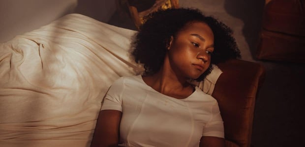 Woman looking pensive while lying down
