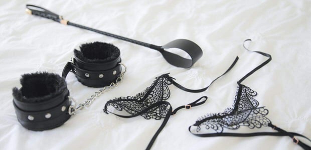 Photo of lingerie, handcuffs, and a whip. Photo of lingerie, handcuffs, and a whip.