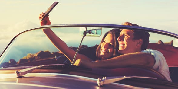 Photo of a couple talking a selfie Photo of a couple talking a selfie
