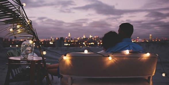 Photo of a couple on a rooftop date Photo of a couple on a rooftop date